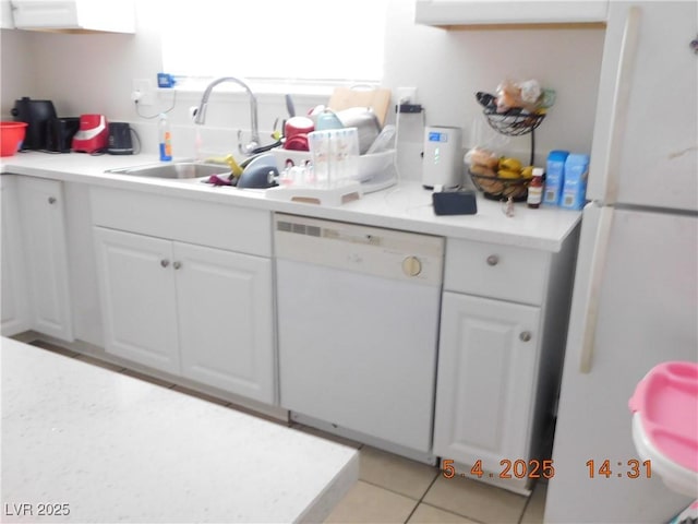 kitchen featuring a sink, white cabinets, white appliances, and light countertops