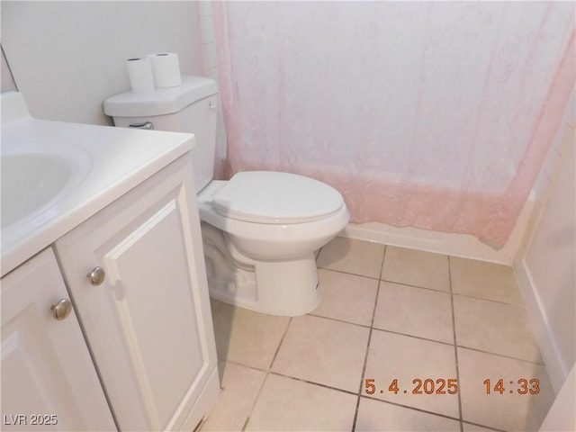 bathroom featuring toilet, tile patterned flooring, and vanity