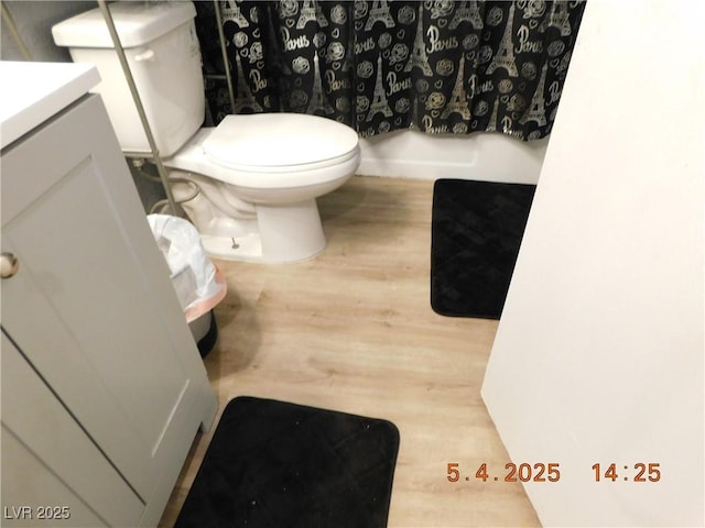 full bathroom featuring toilet, wood finished floors, and vanity