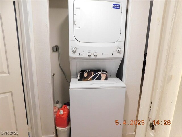 washroom with stacked washer / drying machine