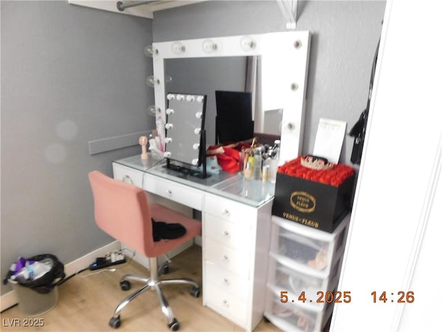 home office with baseboards and wood finished floors