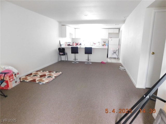 playroom with carpet floors and baseboards