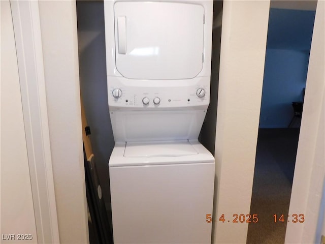 clothes washing area with laundry area and stacked washer and dryer