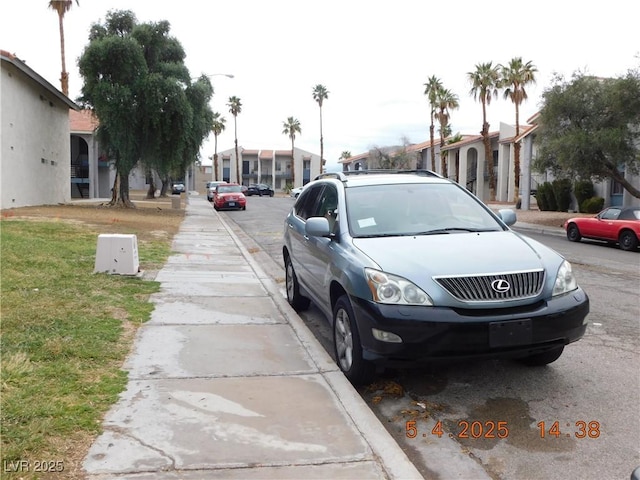 view of road featuring sidewalks and a residential view
