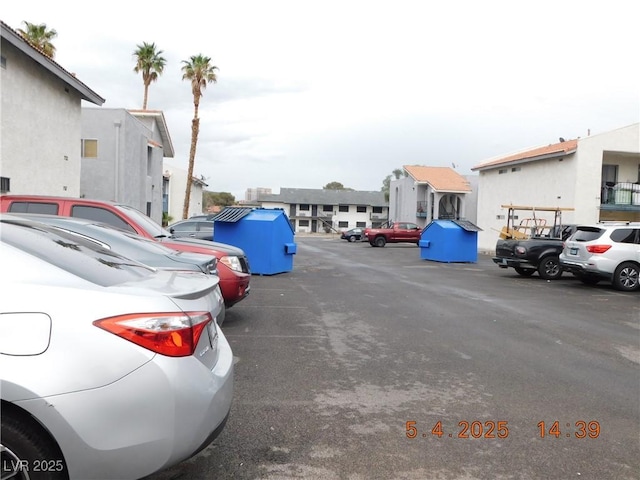 uncovered parking lot with a residential view
