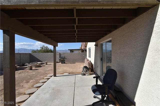 view of patio with a fenced backyard and a mountain view