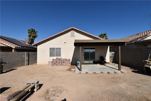back of property featuring a patio area, stucco siding, a tiled roof, and fence