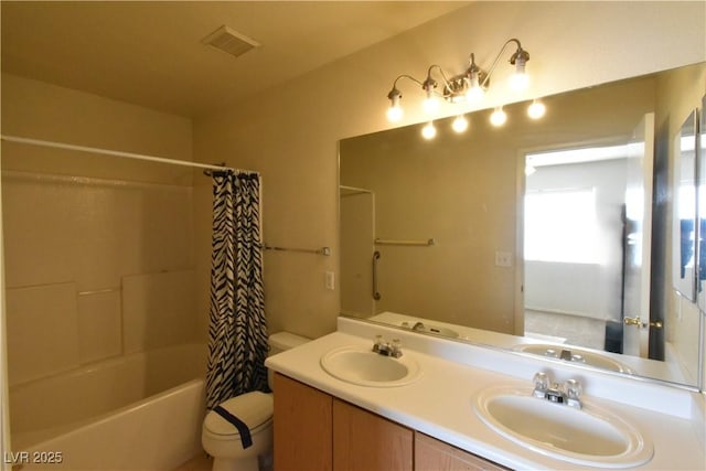 bathroom featuring visible vents, a sink, and toilet