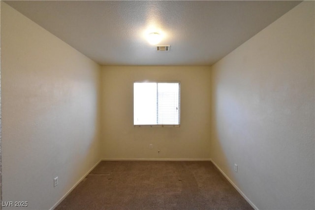 carpeted empty room with visible vents and baseboards