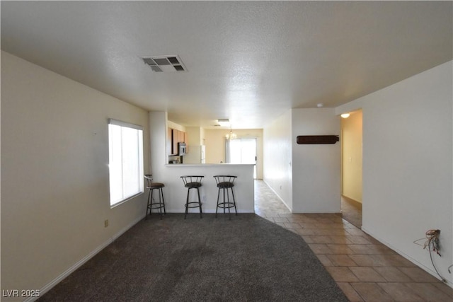 spare room featuring baseboards and visible vents