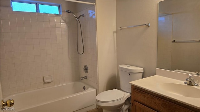 bathroom with vanity, washtub / shower combination, and toilet