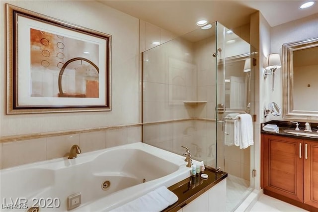 full bath with a whirlpool tub, recessed lighting, a shower stall, and vanity