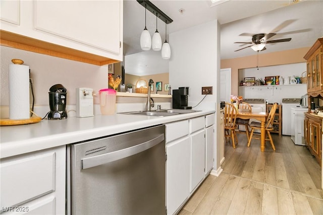 kitchen featuring a ceiling fan, light countertops, separate washer and dryer, a sink, and dishwasher