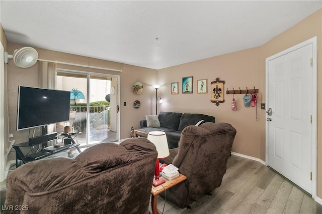 living room with baseboards and light wood-type flooring