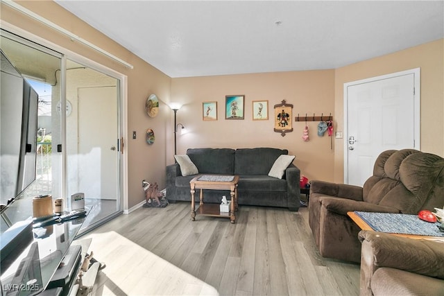 living area with light wood-style floors and baseboards