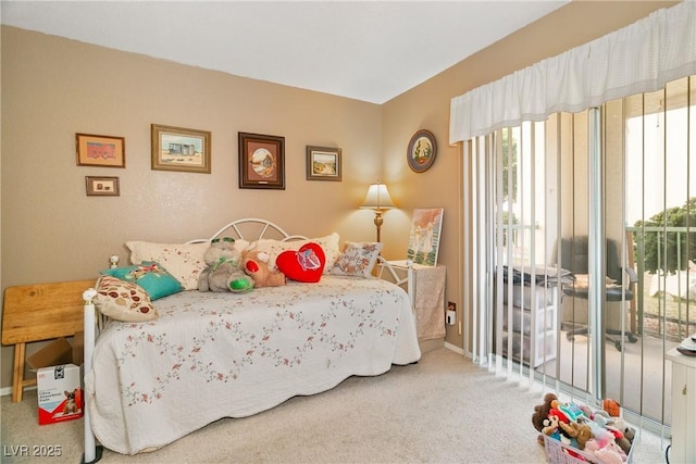bedroom with carpet floors, baseboards, and access to exterior