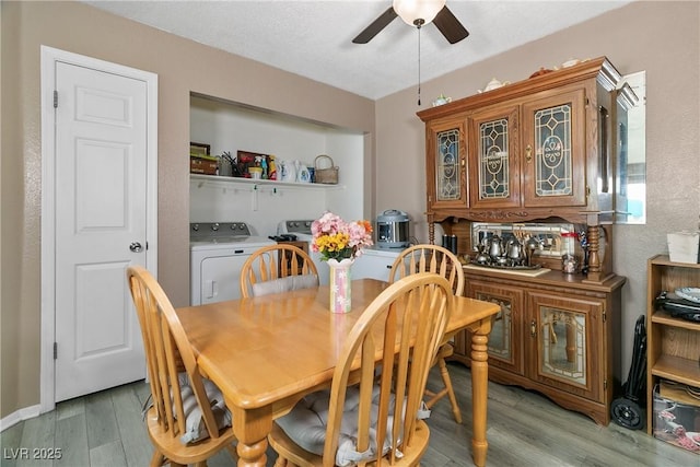 dining area featuring washer and dryer, ceiling fan, and light wood finished floors