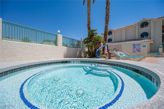 view of swimming pool with a swimming pool and fence