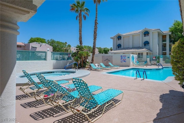 community pool featuring a community hot tub, a patio area, and fence