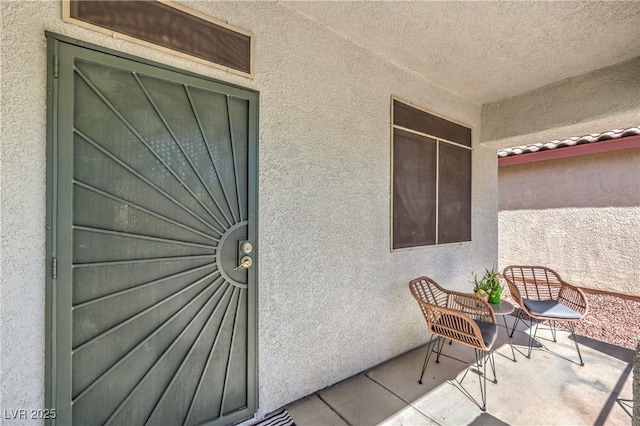 property entrance with stucco siding