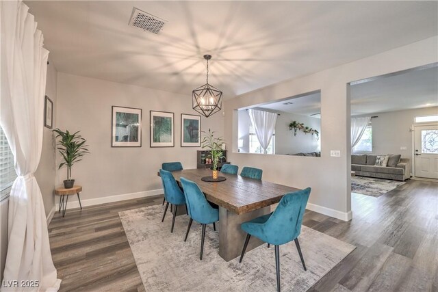 11143 Castellane Dr, Las Vegas, NV 89141 - dining space featuring dark wood-type flooring, a chandelier, and baseboards