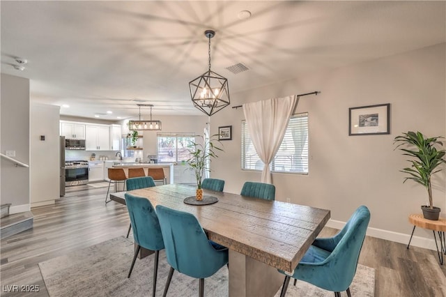 dining area featuring recessed lighting, baseboards, visible vents, and wood finished floors