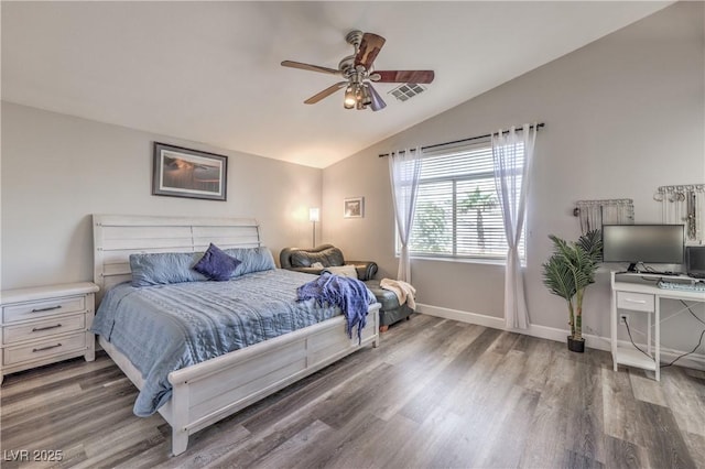 bedroom featuring baseboards, visible vents, wood finished floors, and lofted ceiling