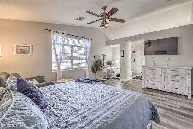 bedroom with ceiling fan, connected bathroom, wood finished floors, and visible vents