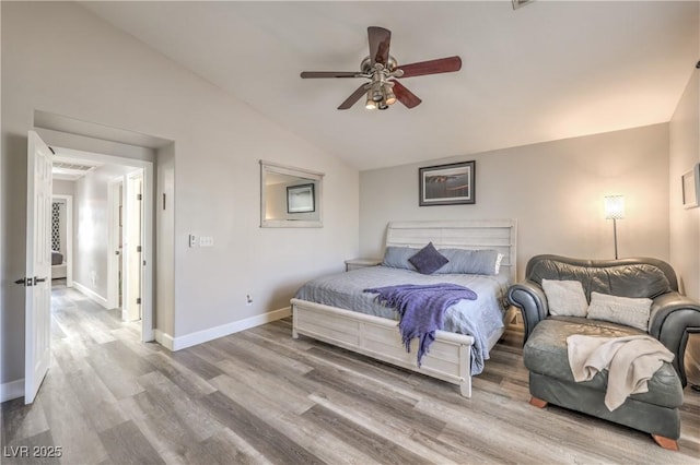 bedroom featuring baseboards, a ceiling fan, wood finished floors, and lofted ceiling