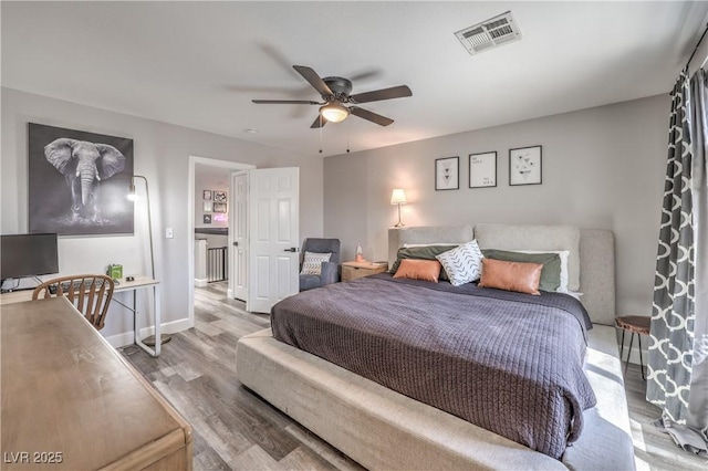 bedroom with visible vents, baseboards, ceiling fan, and wood finished floors