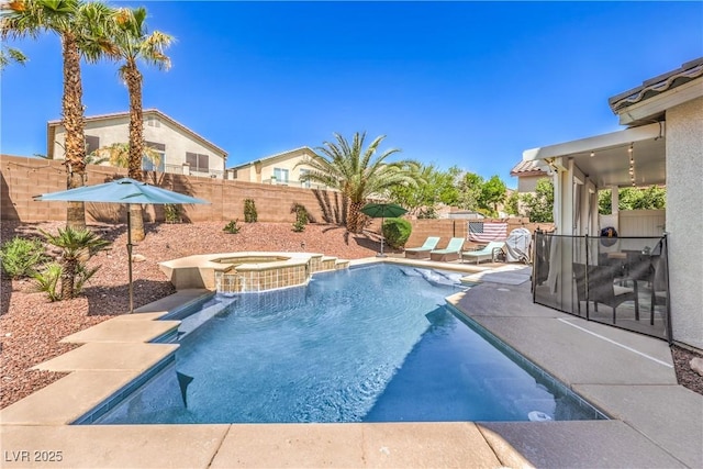 view of swimming pool with a pool with connected hot tub, a fenced backyard, and a patio area