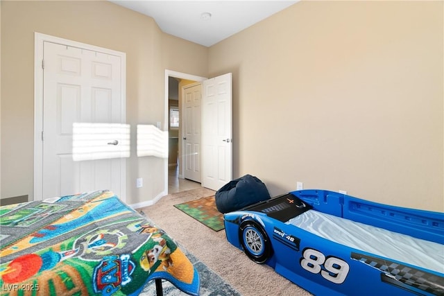 carpeted bedroom featuring baseboards