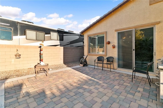 view of patio / terrace featuring fence