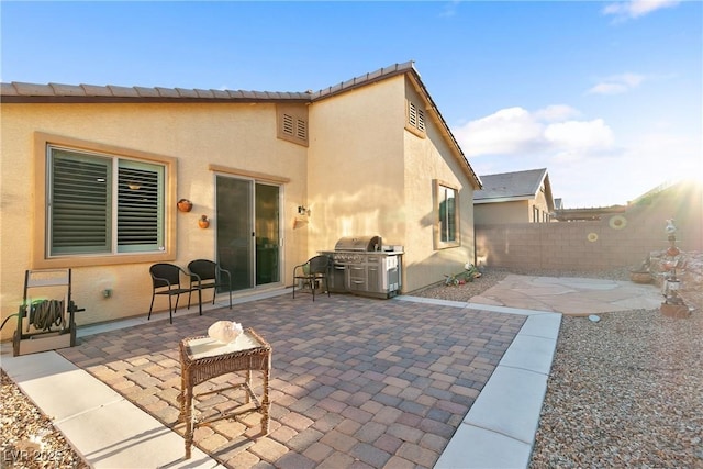 back of property featuring a fenced backyard, stucco siding, and a patio area