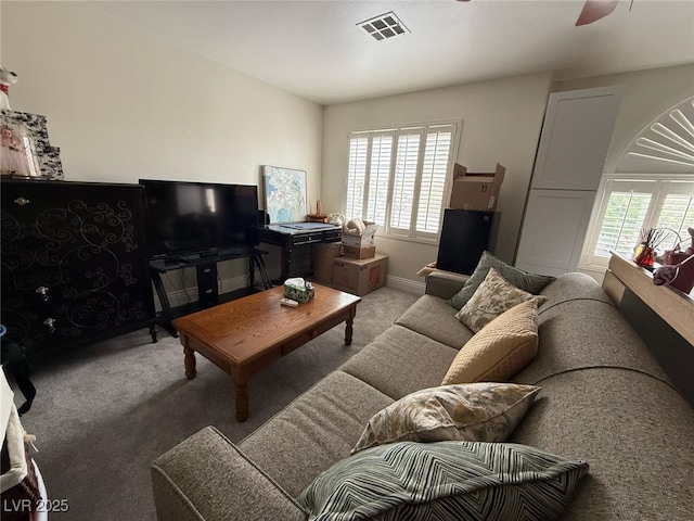 carpeted living room with a ceiling fan and visible vents