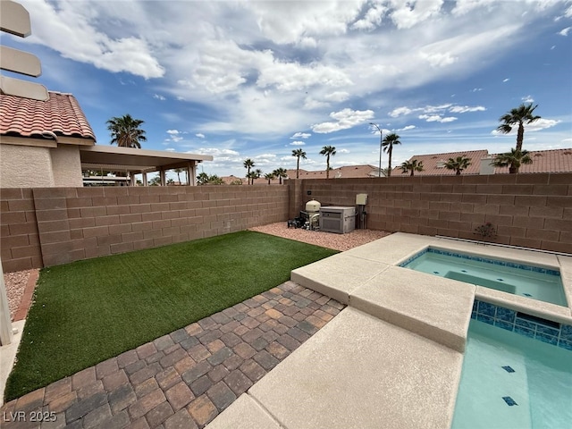 view of pool featuring a fenced backyard, an in ground hot tub, and a patio area