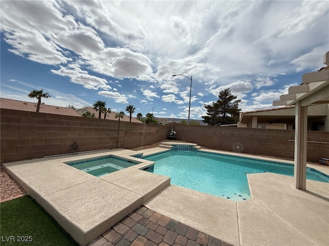 view of pool with a patio, a fenced backyard, and a pool with connected hot tub