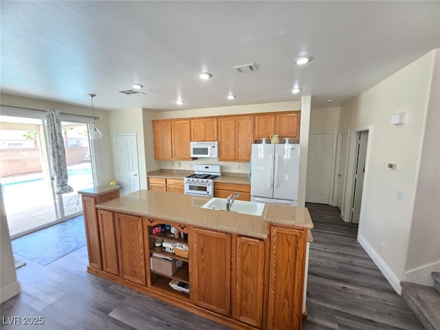 10071 Lemon Valley Ave, Las Vegas, NV 89147 - kitchen featuring white appliances, a sink, dark wood-style flooring, a center island with sink, and recessed lighting