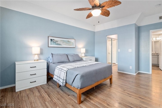 3550 Bay Sands Dr Unit 2101, Laughlin, NV 89029 - bedroom featuring a ceiling fan, baseboards, a closet, connected bathroom, and light wood-style flooring
