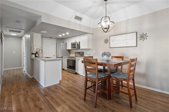 3550 Bay Sands Dr Unit 2101, Laughlin, NV 89029 - dining space with a notable chandelier, wood finished floors, and visible vents