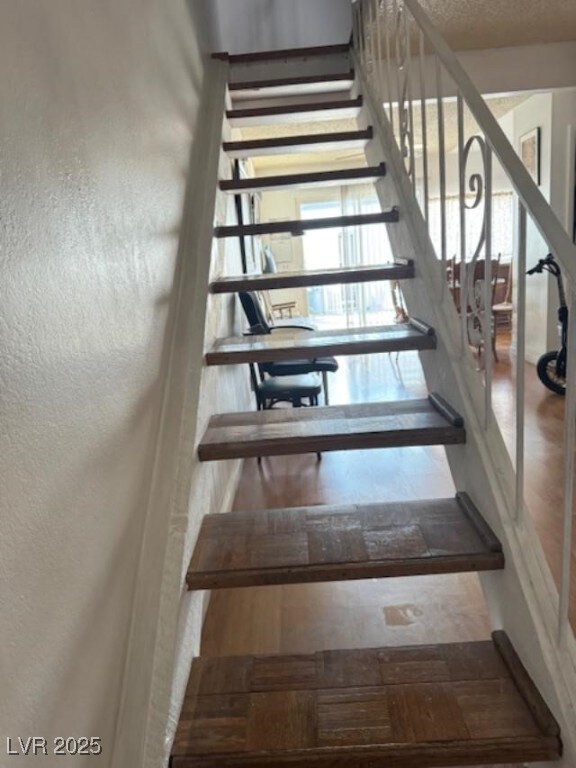 stairs featuring a textured wall