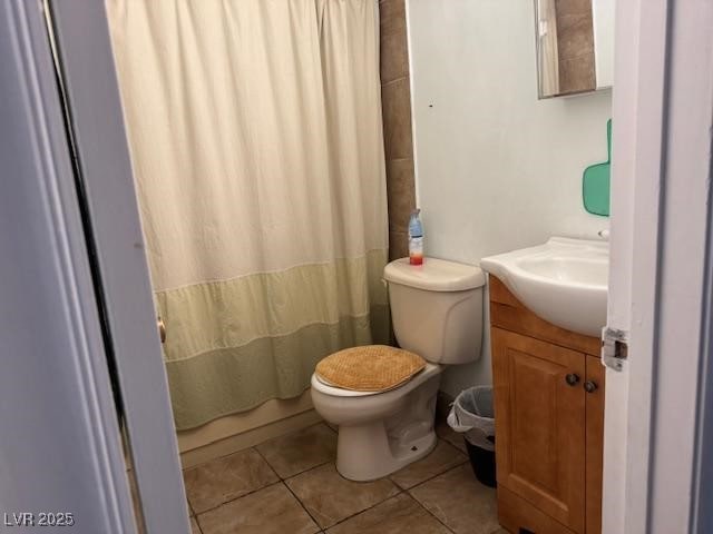 full bathroom with tile patterned floors, vanity, toilet, and curtained shower