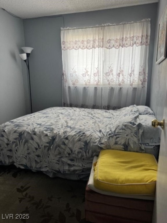 bedroom featuring carpet floors and a textured ceiling