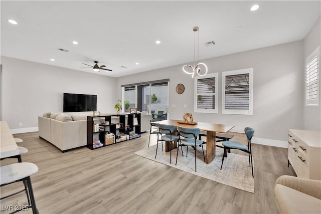 dining room featuring baseboards, recessed lighting, and light wood-style flooring