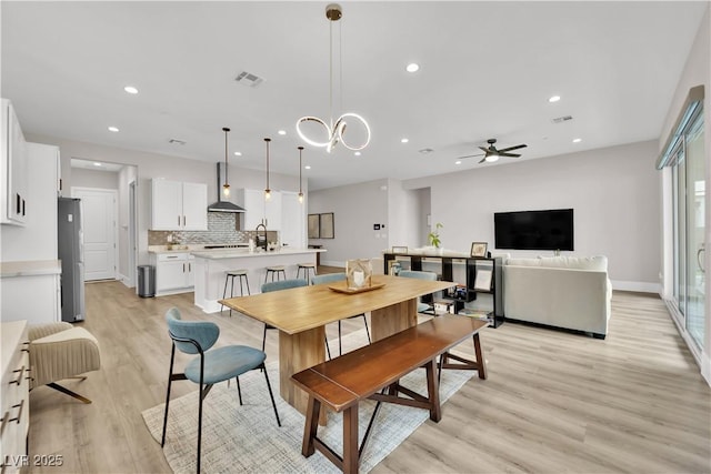 dining space featuring ceiling fan, light wood-type flooring, recessed lighting, and visible vents