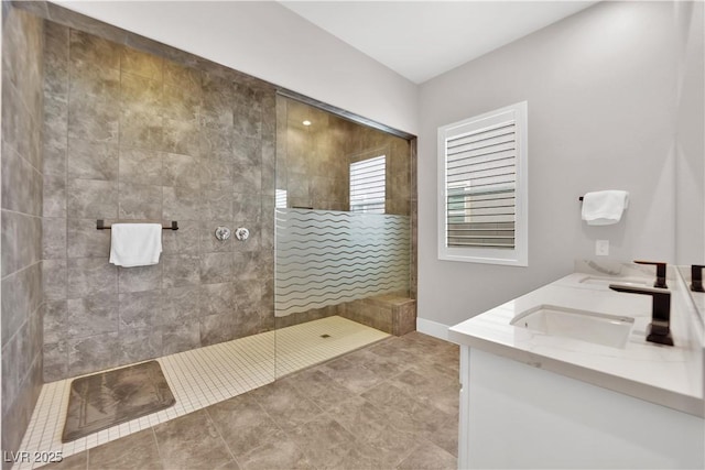 bathroom featuring a sink, tile patterned floors, walk in shower, and double vanity