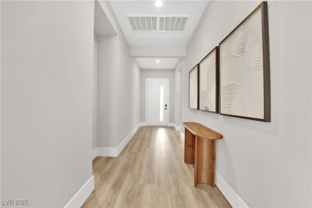 hallway featuring visible vents, recessed lighting, baseboards, and light wood-type flooring