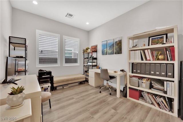 office space with recessed lighting, wood finished floors, and visible vents