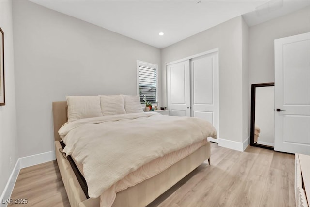 bedroom featuring baseboards, a closet, recessed lighting, and light wood-style flooring