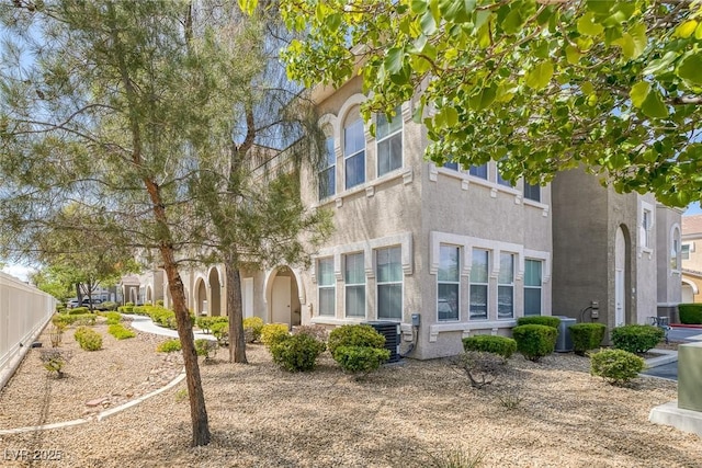 exterior space with stucco siding and central AC
